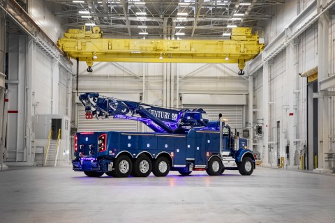 rear of a blue century m100 rotator in an industrial building