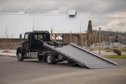black hino 258 with a 12 series lcg carrier bed tilted back